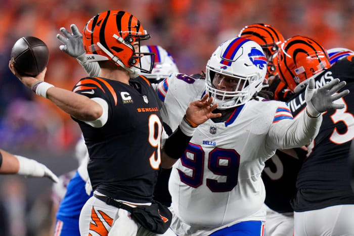 Cincinnati Bengals quarterback Joe Burrow (9) throws under pressure from Buffalo Bills defensive tackle Tim Settle (99). © Sam Greene/The Enquirer / USA TODAY NETWORK